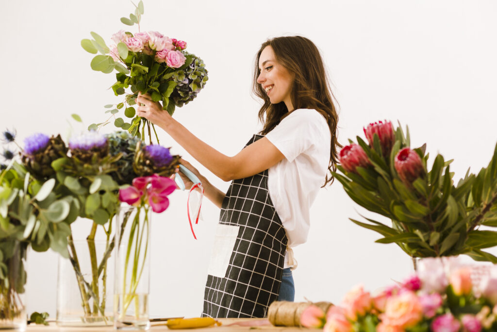 medium shot smiley florist making bouquet (1)