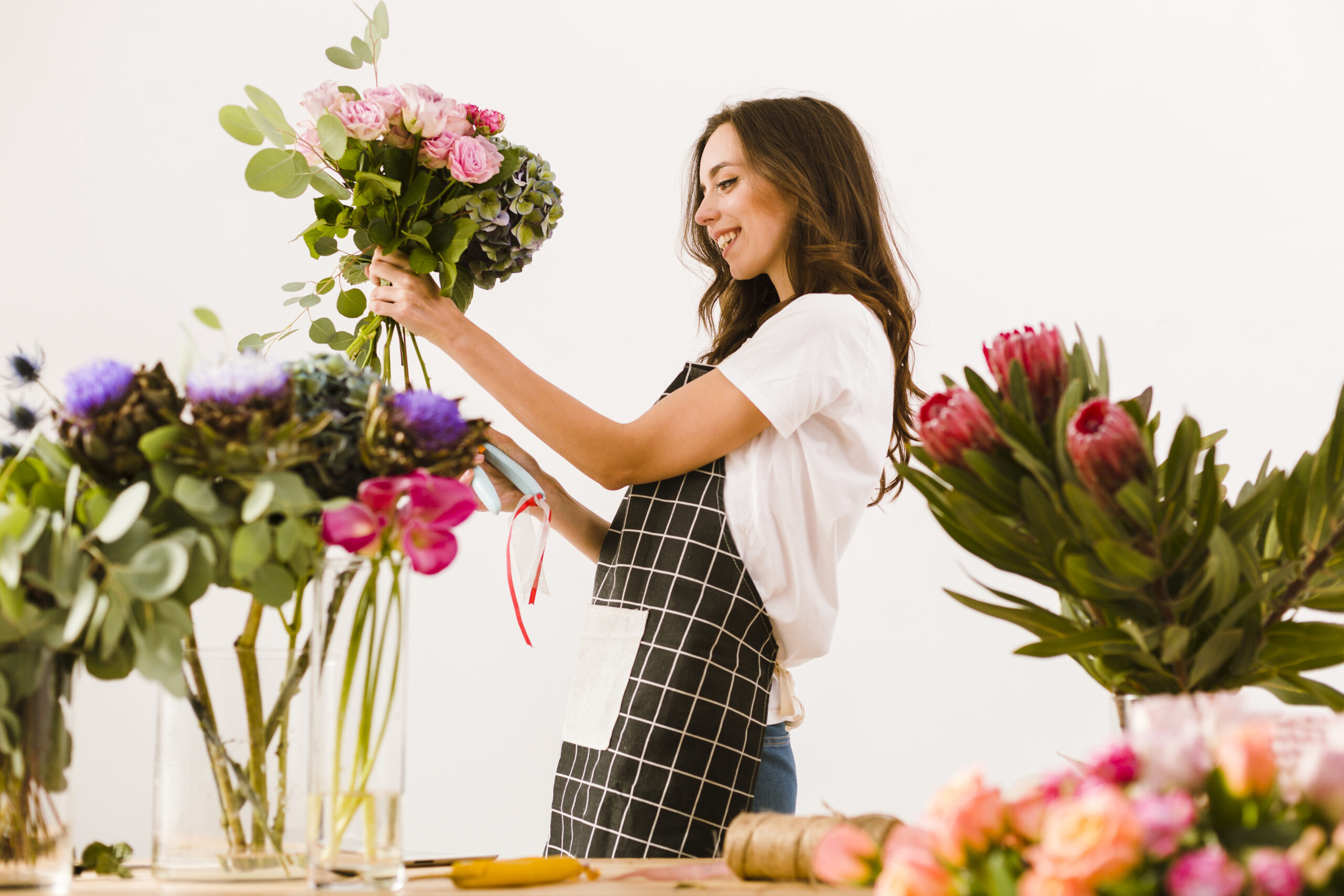 medium shot smiley florist making bouquet (1)